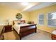 Bright bedroom with yellow walls, large windows, and a sleigh bed for a cozy retreat at 13943 W 87Th Ln, Arvada, CO 80005