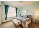 Comfortable bedroom featuring a large bed, bench, and stylish decor at 13943 W 87Th Ln, Arvada, CO 80005