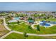 Aerial perspective showcasing community pool, clubhouse, playground, and well-maintained landscaping at 13943 W 87Th Ln, Arvada, CO 80005