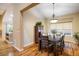 Formal dining room with chandelier and large window for natural light at 13943 W 87Th Ln, Arvada, CO 80005