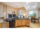 Well-lit kitchen with granite countertops and open layout to the dining and living area at 13943 W 87Th Ln, Arvada, CO 80005
