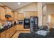 Modern kitchen with stainless steel appliances, a tile backsplash, and wood cabinets at 13943 W 87Th Ln, Arvada, CO 80005