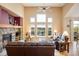 Inviting living room with stone fireplace, large windows, and comfortable seating at 13943 W 87Th Ln, Arvada, CO 80005