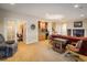 Spacious living room featuring a wet bar, carpeted floors, and ample space for entertaining or relaxing at 13943 W 87Th Ln, Arvada, CO 80005