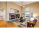 Inviting living room with a stone fireplace, hardwood floors, vaulted ceiling and plenty of natural light at 13943 W 87Th Ln, Arvada, CO 80005