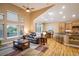 Spacious living area with vaulted ceilings, an open layout, hardwood floors, and a kitchen with an island and dining area at 13943 W 87Th Ln, Arvada, CO 80005