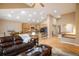 An open-concept space with hardwood floors, vaulted ceilings, a kitchen with an island, a dining area, and comfortable seating at 13943 W 87Th Ln, Arvada, CO 80005