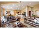 Spacious open-concept living room flowing into a gourmet kitchen with a large island and seating at 13943 W 87Th Ln, Arvada, CO 80005