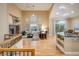 Open living room with a fireplace, hardwood floors, lots of windows, and an adjacent kitchen and dining area at 13943 W 87Th Ln, Arvada, CO 80005