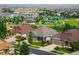 Scenic neighborhood view showcasing well-maintained homes, green spaces, and a playground at 13943 W 87Th Ln, Arvada, CO 80005