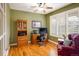 Comfortable office space with a hardwood floor, built-in storage, and natural light from the shuttered windows at 13943 W 87Th Ln, Arvada, CO 80005