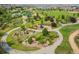 Aerial view of a beautifully landscaped park with walking paths, gardens, and community amenities at 13943 W 87Th Ln, Arvada, CO 80005