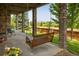 Inviting covered patio with a swing and picturesque neighborhood views at 13943 W 87Th Ln, Arvada, CO 80005