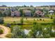 Scenic pond view overlooking neighborhood homes and lush greenery, ideal for relaxation at 13943 W 87Th Ln, Arvada, CO 80005