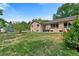 Expansive backyard with lush lawn and mature trees, offering privacy and space for outdoor activities at 6307 S Gallup St, Littleton, CO 80120