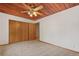 Bedroom featuring a wood plank ceiling, carpeted floors, closet, and door at 6307 S Gallup St, Littleton, CO 80120