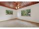 Bedroom featuring a wood plank ceiling, carpeted floors, and bright windows at 6307 S Gallup St, Littleton, CO 80120