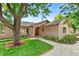 Charming brick home with an arched front door and mature landscaping, perfect for curb appeal at 6307 S Gallup St, Littleton, CO 80120