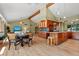 Open layout seamlessly blends kitchen and living space with hardwood floors, vaulted ceilings, and abundant cabinetry at 6307 S Gallup St, Littleton, CO 80120