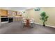 Basement kitchen area with table and chairs, plus a full range and oven, offering extra space to cook at 6307 S Gallup St, Littleton, CO 80120