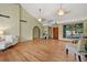 Bright living room features hardwood floors, a vaulted ceiling, and a large window at 6307 S Gallup St, Littleton, CO 80120