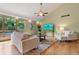 Bright living room with large windows, hardwood floors, and a vaulted ceiling at 6307 S Gallup St, Littleton, CO 80120