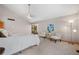 The airy main bedroom has a vaulted ceiling, a sitting area with chairs, and ample natural light from a large glass door at 6307 S Gallup St, Littleton, CO 80120