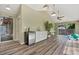 Bright recreation room with vaulted ceilings, wet bar, and space for exercise equipment with access to the outdoors at 6307 S Gallup St, Littleton, CO 80120
