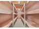 Unfinished basement storage space with unfinished ceiling and wooden shelving, ideal for organization at 6307 S Gallup St, Littleton, CO 80120
