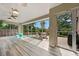 Sunroom featuring floor-to-ceiling windows, backyard view, and a ceiling fan at 6307 S Gallup St, Littleton, CO 80120