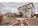 Spacious backyard with large patio, rock landscaping, and deck with exterior stairs at 2028 Trail Stone Ct, Castle Rock, CO 80108
