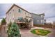Backyard features large patio, rock landscaping, yard with deck and exterior stairs at 2028 Trail Stone Ct, Castle Rock, CO 80108
