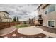 Backyard features large patio area, rock landscaping, and deck with exterior stairs at 2028 Trail Stone Ct, Castle Rock, CO 80108