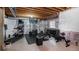 Finished basement with home gym featuring treadmill, weights, and exposed beams at 2028 Trail Stone Ct, Castle Rock, CO 80108
