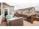 Inviting outdoor deck with wicker seating, wrought iron railing, and gas grill at 2028 Trail Stone Ct, Castle Rock, CO 80108