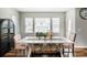Bright dining area with a white table, patterned chairs, bench seating, and natural light from large windows at 2028 Trail Stone Ct, Castle Rock, CO 80108