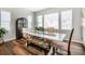 Comfortable dining area featuring a white table, decorative chairs, bench seating, and ample natural light at 2028 Trail Stone Ct, Castle Rock, CO 80108