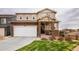 Charming two-story home features a two-car garage and a well-maintained front lawn at 2028 Trail Stone Ct, Castle Rock, CO 80108