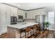 Modern kitchen boasts stainless steel appliances, white cabinetry, and a spacious center island at 2028 Trail Stone Ct, Castle Rock, CO 80108