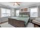 Spacious main bedroom with large windows, plush bedding, and stylish decor at 2028 Trail Stone Ct, Castle Rock, CO 80108