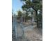 Rustic home exterior nestled amongst mature trees, featuring a gated entrance and gravel driveway at 433 Gunn Ave, Berthoud, CO 80513