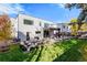 Beautifully landscaped backyard with patio, seating area, and lush green lawn at 42 S Ash St, Denver, CO 80246