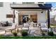 An elegant backyard patio offers inviting spaces for dining, lounging, and enjoying the outdoors at 42 S Ash St, Denver, CO 80246