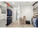 Walk-in closet featuring custom shelving, wood floors, and ample space for clothing and accessories at 42 S Ash St, Denver, CO 80246