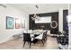 Bright dining area features sleek modern lighting and seating for eight at 42 S Ash St, Denver, CO 80246