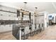 Modern kitchen featuring a waterfall island with seating, stainless steel appliances, and designer lighting at 42 S Ash St, Denver, CO 80246