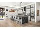 Modern kitchen boasts a large island with seating, stainless steel appliances, and sleek cabinetry at 42 S Ash St, Denver, CO 80246