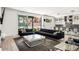 Open-concept living room leading to the kitchen with a modern couch and coffee table at 42 S Ash St, Denver, CO 80246