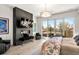 Main bedroom featuring a black fireplace, television, a black fur bench, and balcony access at 42 S Ash St, Denver, CO 80246