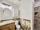 Cozy bathroom with decorative tiling, a functional sink, and a convenient shower, offering a practical space at 14310 Kalamath St, Westminster, CO 80023